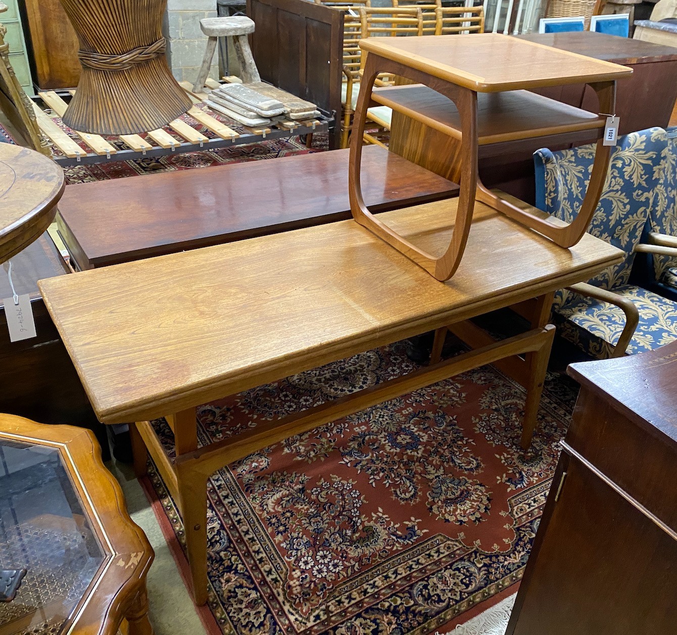 A mid century Trioh type “Copenhagen” metamorphic teak coffee / dining table, width 150cm, depth 54cm, height 72cm and a Nathan teak square occasional table.
